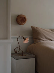 PH 1/1 Piano Table Lamp beside a bed