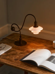 PH 1/1 Piano Table Lamp on a desk