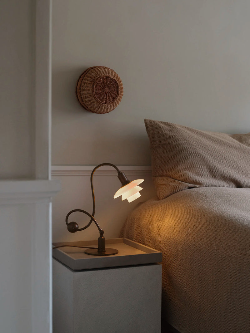 PH 1/1 Piano Table Lamp on a bedside table